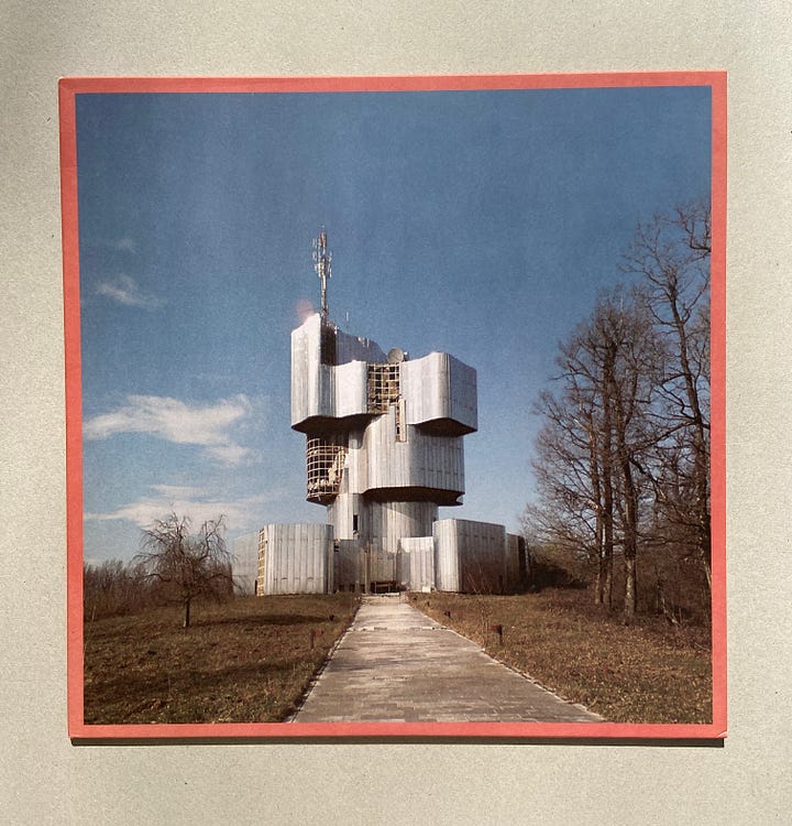 the front and back covers for UMO's debut album. the first picture is a fun architectural piece captured in front of a clear blue sky. the back cover includes the tracklist in white text on a dusty rose background.