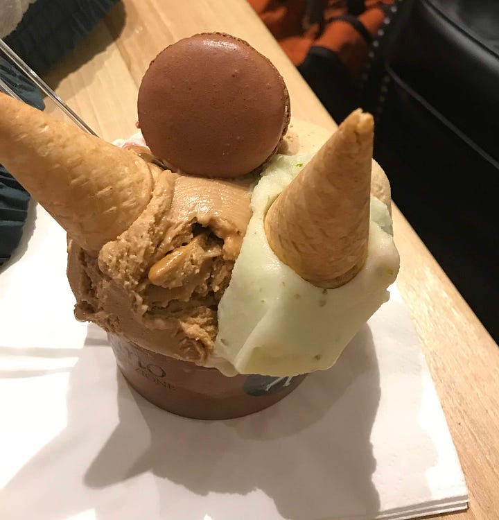 One bowl of salted caramel ice cream and a macaroon cookie, one cup of rolled matcha ice cream