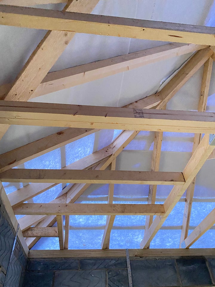 wooden beams positioned for the ceiling