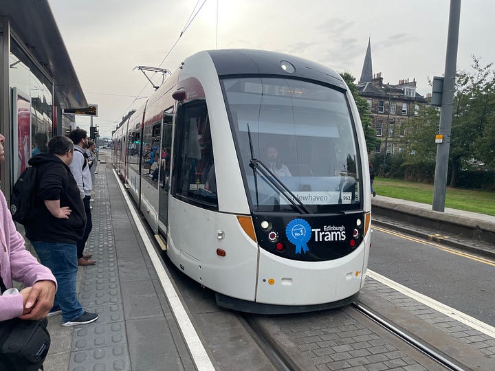 One picture is of a Lothian Bus. Another is of a tram. Another is a picture of my feet sat atop Arthur's Seat. And the final one is some blackberries.