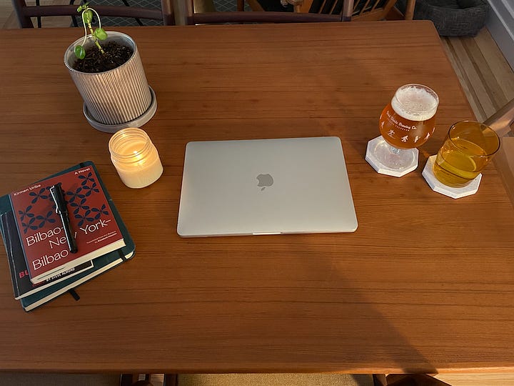 Two photos of a laptop on a dining room table at night
