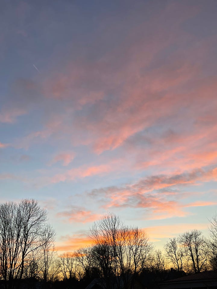 four images showing sunsets of the same view but different days, one with light blue sky and soft pink clouds, one with a dark blue sky and soft pink clouds and two with intense pink and orange clouds