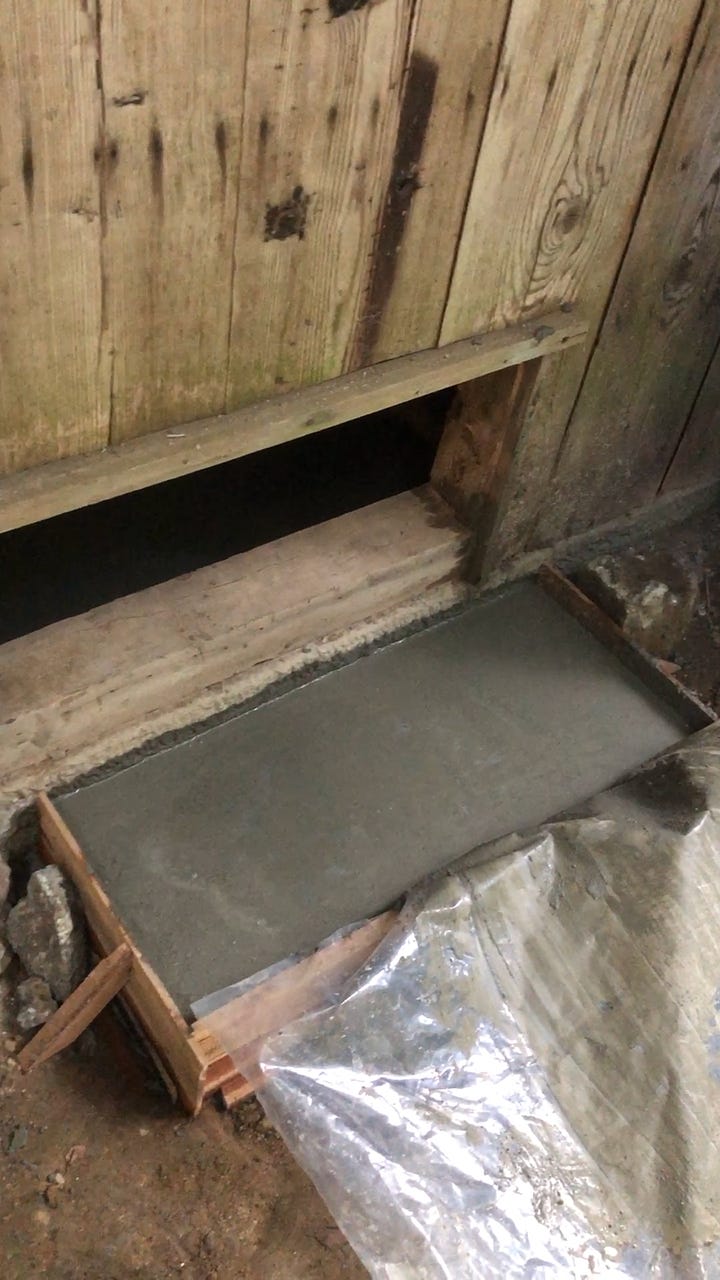 Digging under the old foundation to pour new reinforced concrete footings