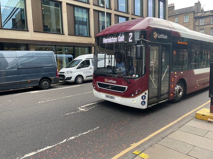 One picture is of a Lothian Bus. Another is of a tram. Another is a picture of my feet sat atop Arthur's Seat. And the final one is some blackberries.