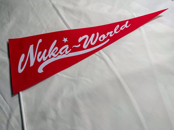 Triangle red flag on a white stick with white text saying Nuka World