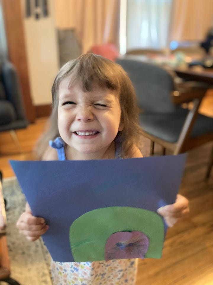 Photos show two children holding art inspired by the cover of THE CAVE