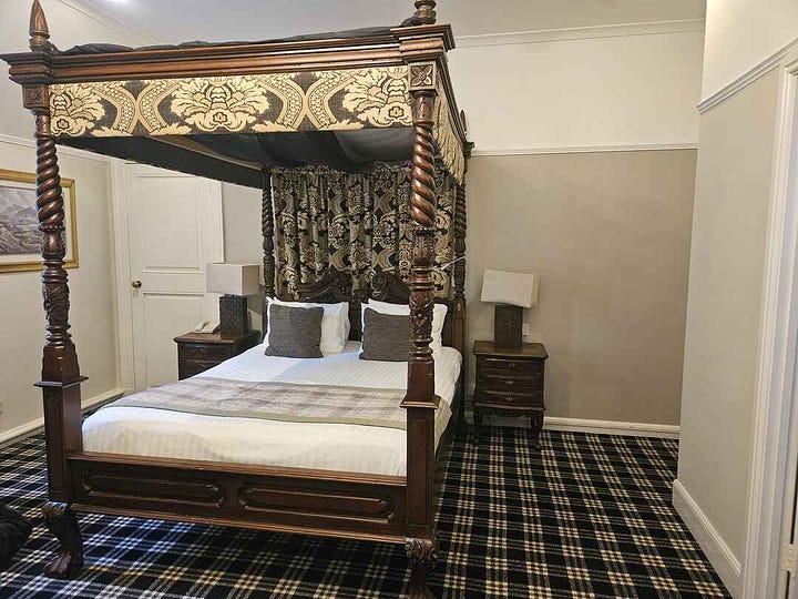 Four poster bed room with fireplace at tulloch castle