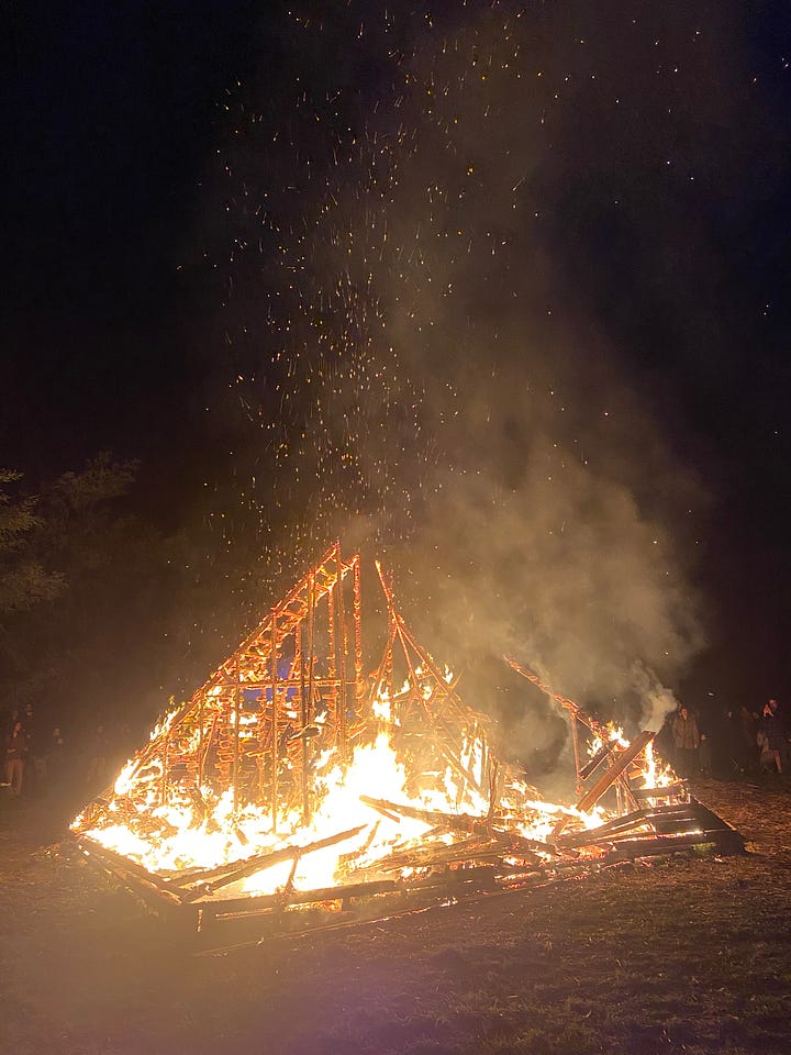 Series of images of large timber pyramid structure in open space as fire takes hold and it burns to the ground