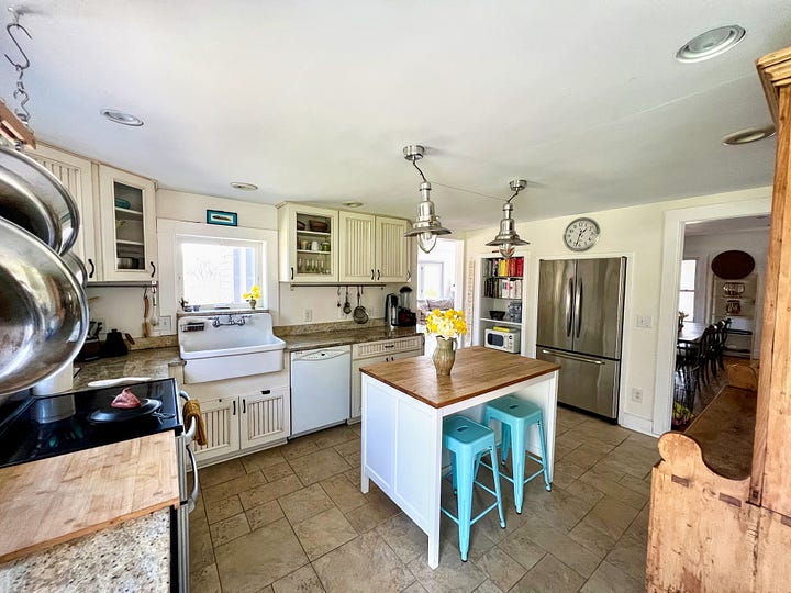 Kitchen with a large sink and an island in the centre.