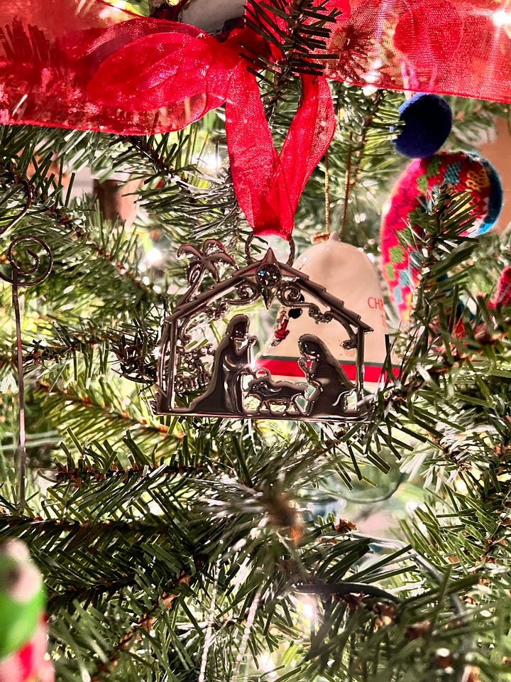 image 1 is of a lego set sitting under a tree, image 2 is of an ornament hanging on a tree