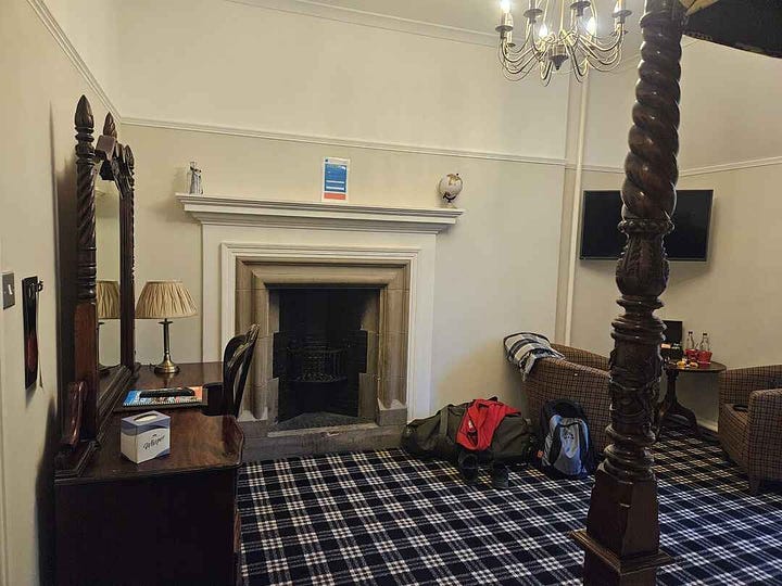 Four poster bed room with fireplace at tulloch castle