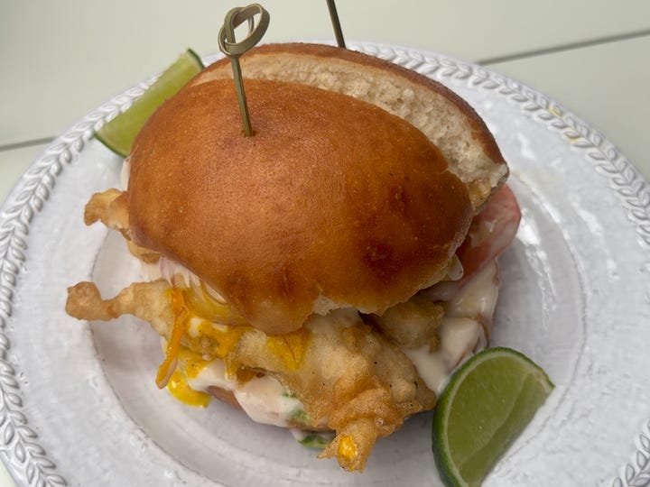 Fried lenguado smothered with aji and mayo in between brioche buns.