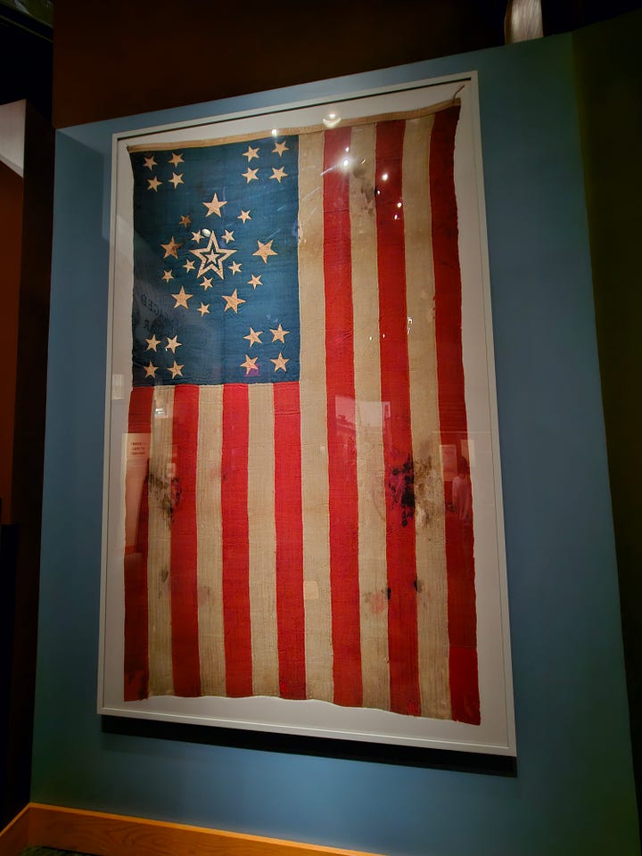 A flag and a confederate soldier at the gettysburg visitor center.