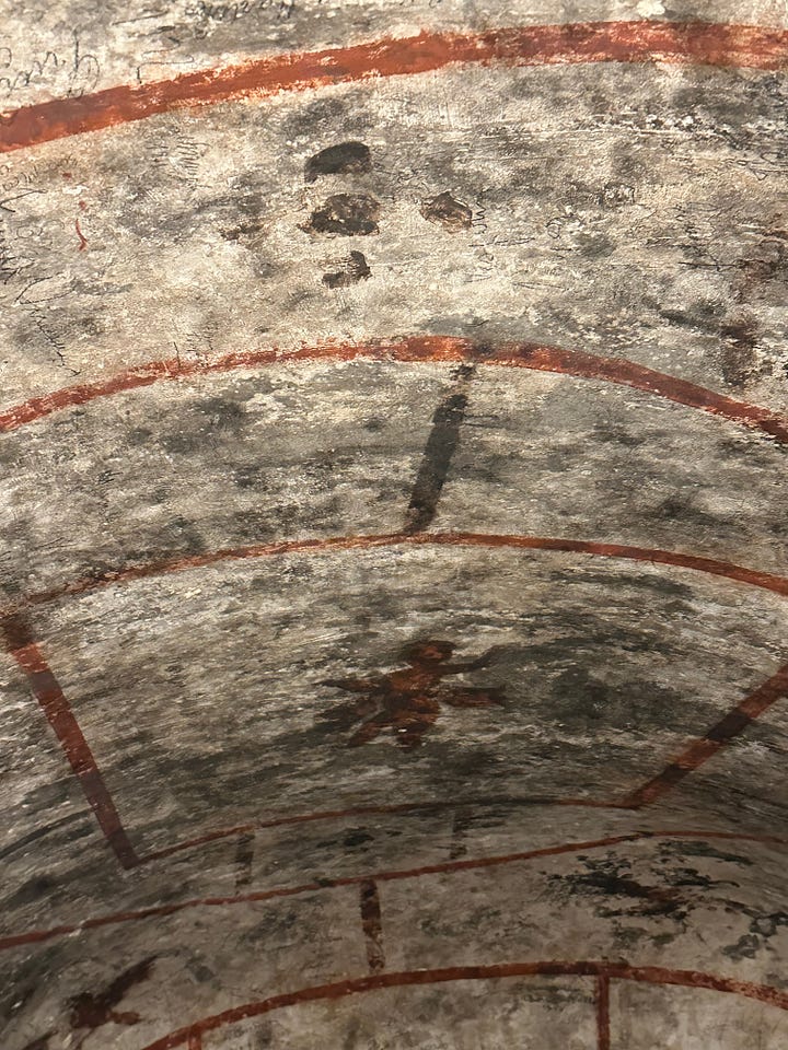 The tomb of Saint Felix adorned with decorations, including an angel, a dove and a fish