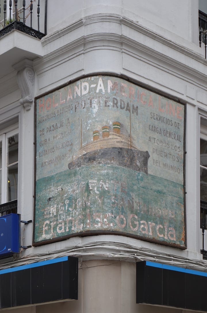 Hand-painted sign on a curved corner wall with lettering and a picture of a boat illustration.