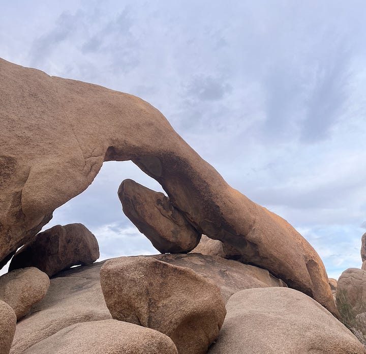 image of sign and rock arch formation referenced