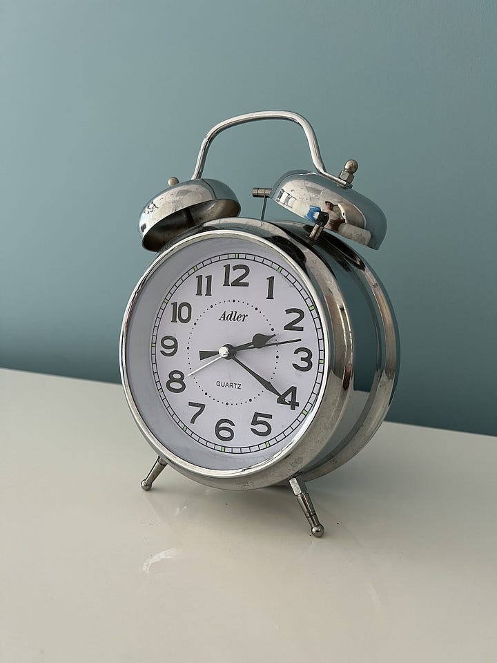 LEFT: A photograph I took of a clock in my office. RIGHT: Midjourney generated this using the clock image and the prompt, "silver clock, hyperrealistic"
