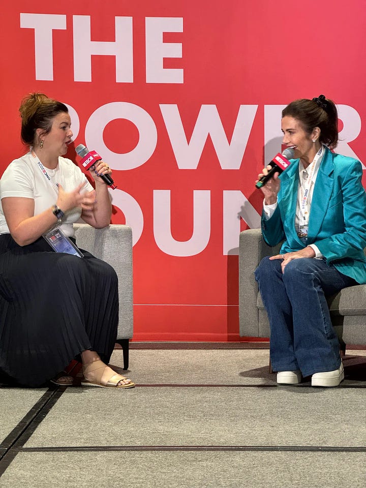 Amber and Lynda Carter speak onstage.