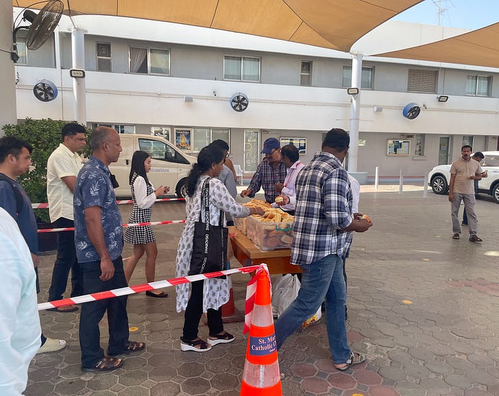Parishioners line up after a weekday Mass at St. Mary's Catholic Church in Dubai, for a loaf of bread. Credit: JD Flynn/Pillar Media.
