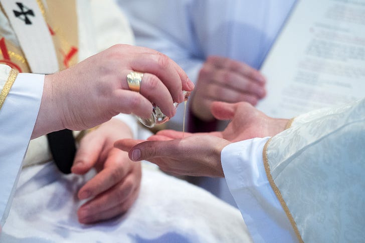 A candidate’s hands are anointed with the oil of chrism during a priestly ordination. © Mazur/cbcew.org.uk.