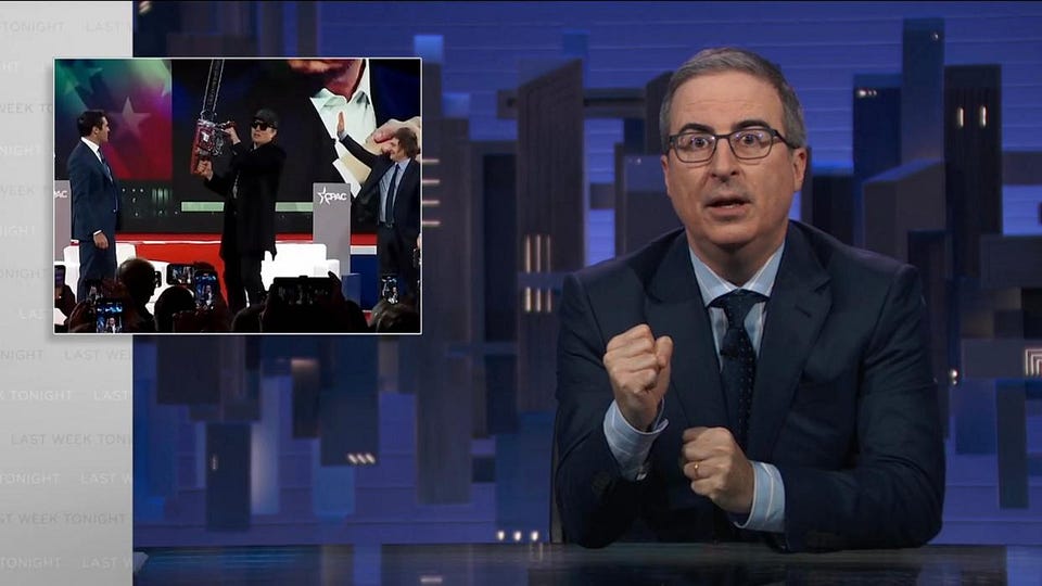 Last Week Tonight screenshot: the host at his desk beside an inset of a man raising a chainsaw on a CPAC stage