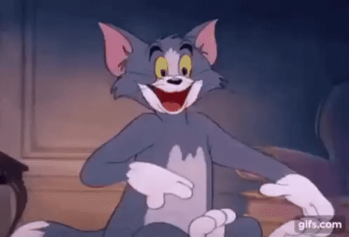 Tom, the grey and white cartoon cat from Tom and Jerry, sat wiping his brow, with a great grin on his face, thankful that everything is ok, for now. PHEW!