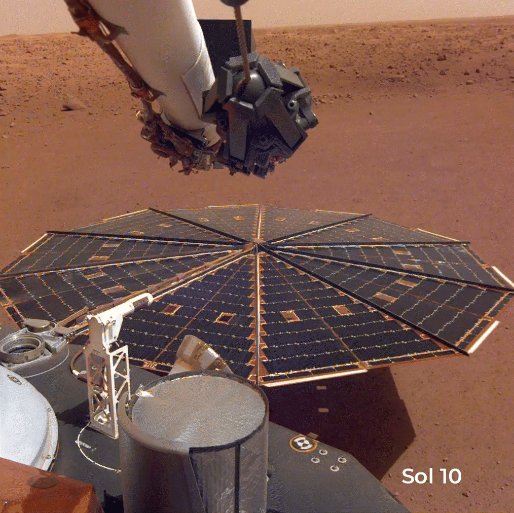 Animated image sequence from NASA’s InSight lander on Mars shows photos of one of the lander’s solar panels at various stages throughout the mission. From the tenth Martian day of its mission (Sol 10) through Sols 106, 578, and 1211, more and more dust accumulation is seen, gradually covering and obscuring the details of the initially clean solar panel. Part of the lander’s robotic arm is seen at the top of the images.