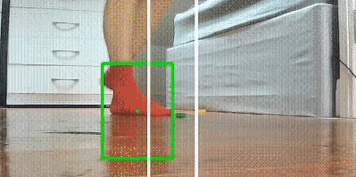 A person ties to avoid stepping on lego bricks that are fired at their feet by a motion tracking robot.