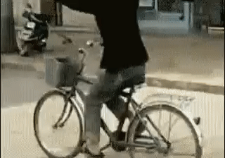 Guy Carrying Mattress On Bike GIF